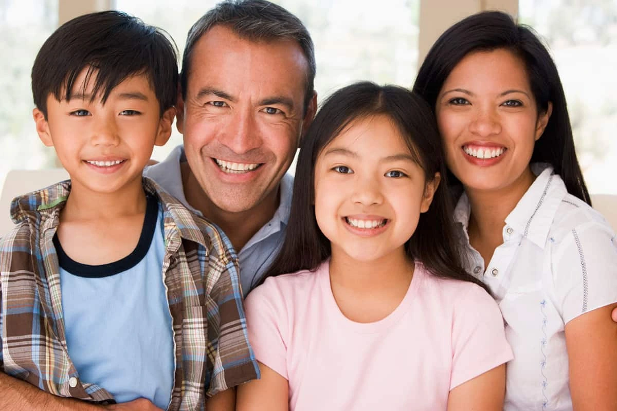 Parents and two children smiling for a family portrait